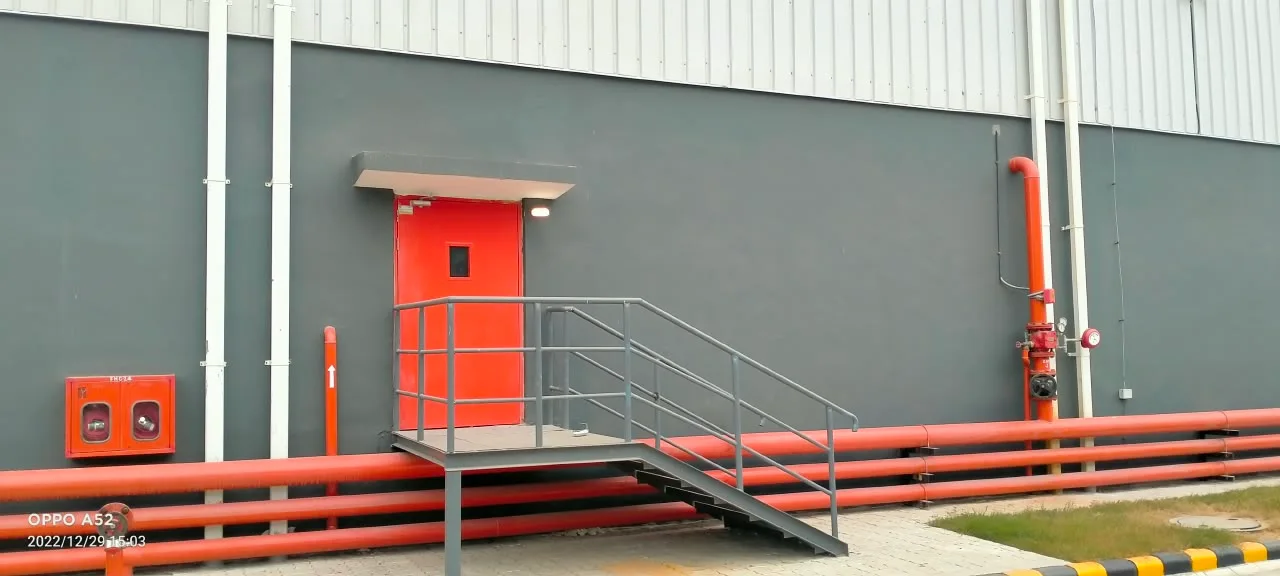 Site admin block entrance with ramp and red door