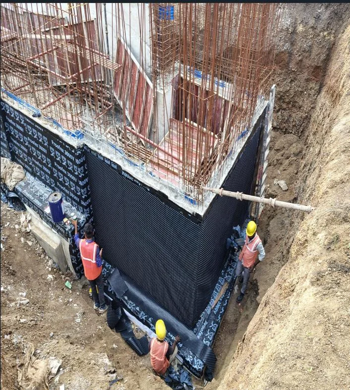 Foundation waterproofing membrane being laid