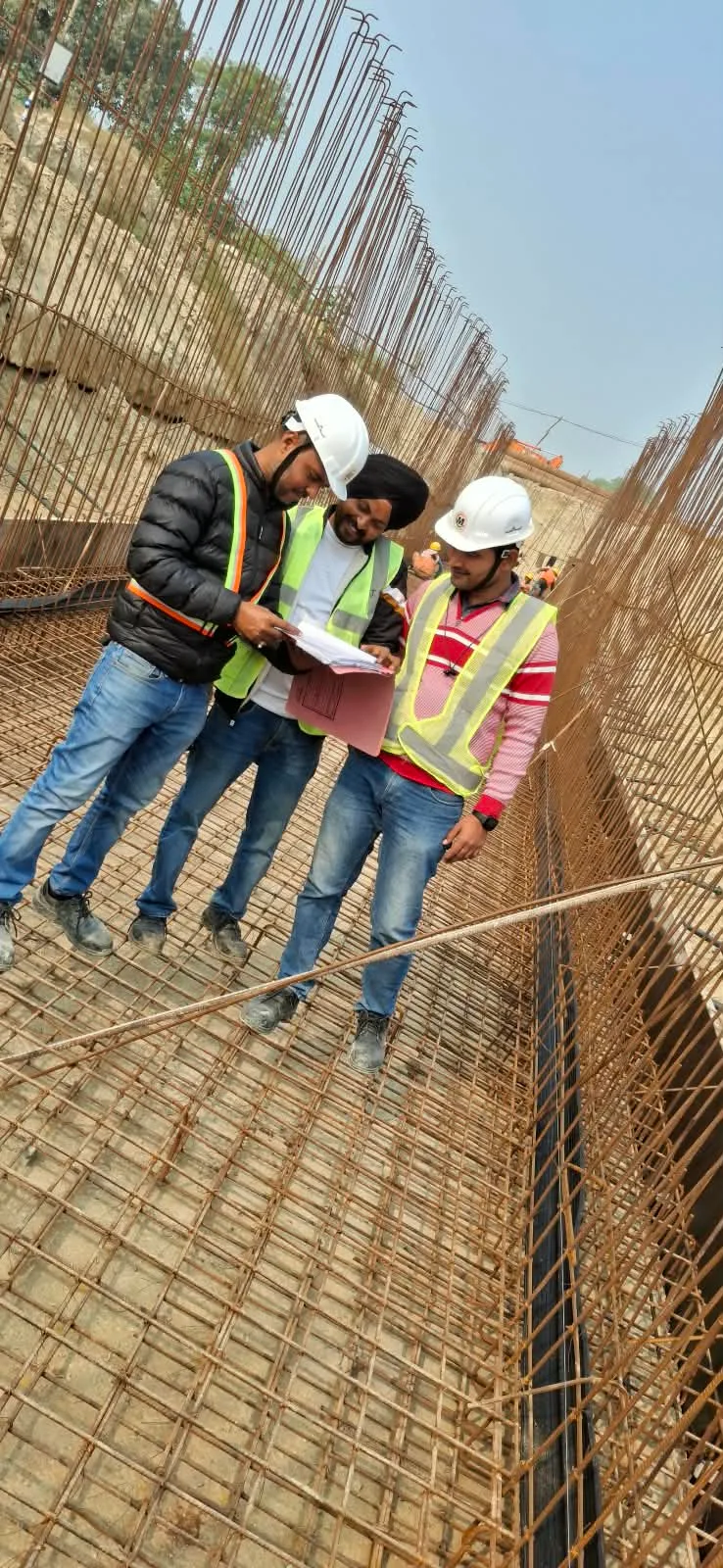 Site engineers inspecting a reinforcement cage for a culvert structure