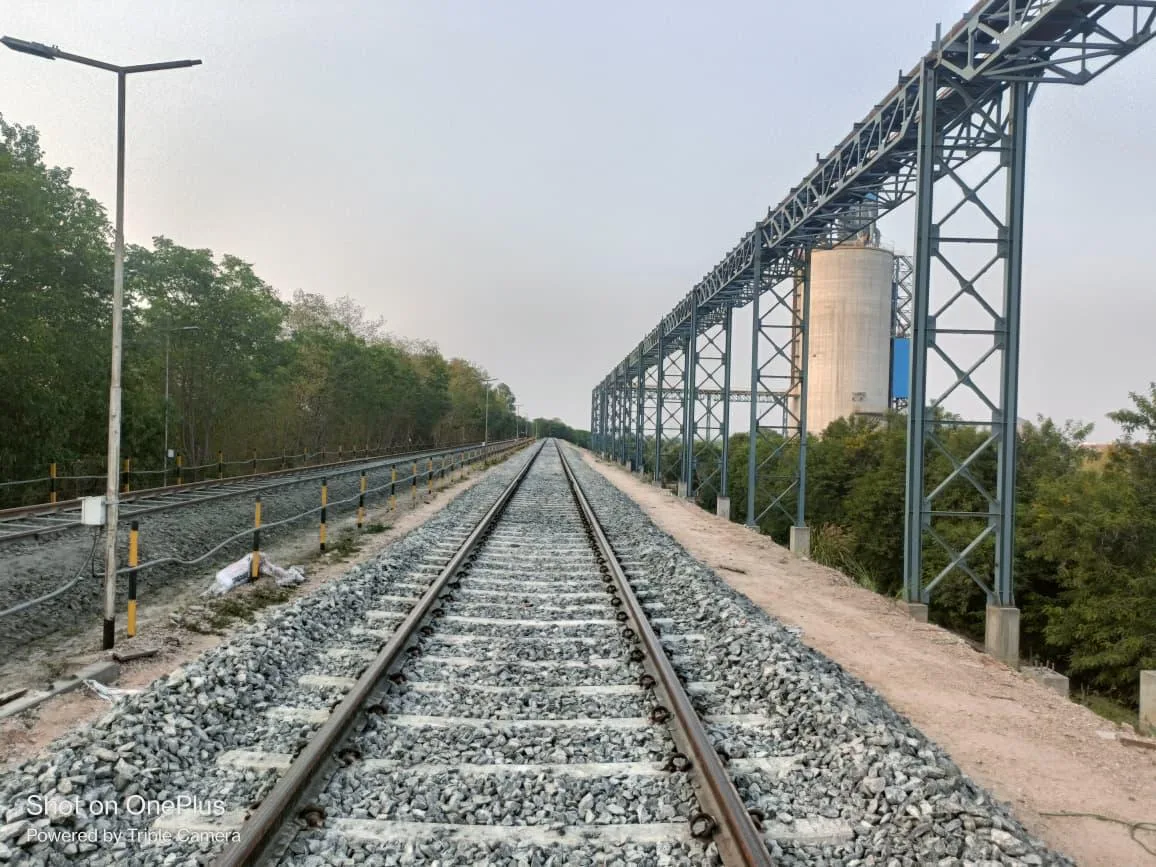 Completed siding track running alongside a silo conveyor structure