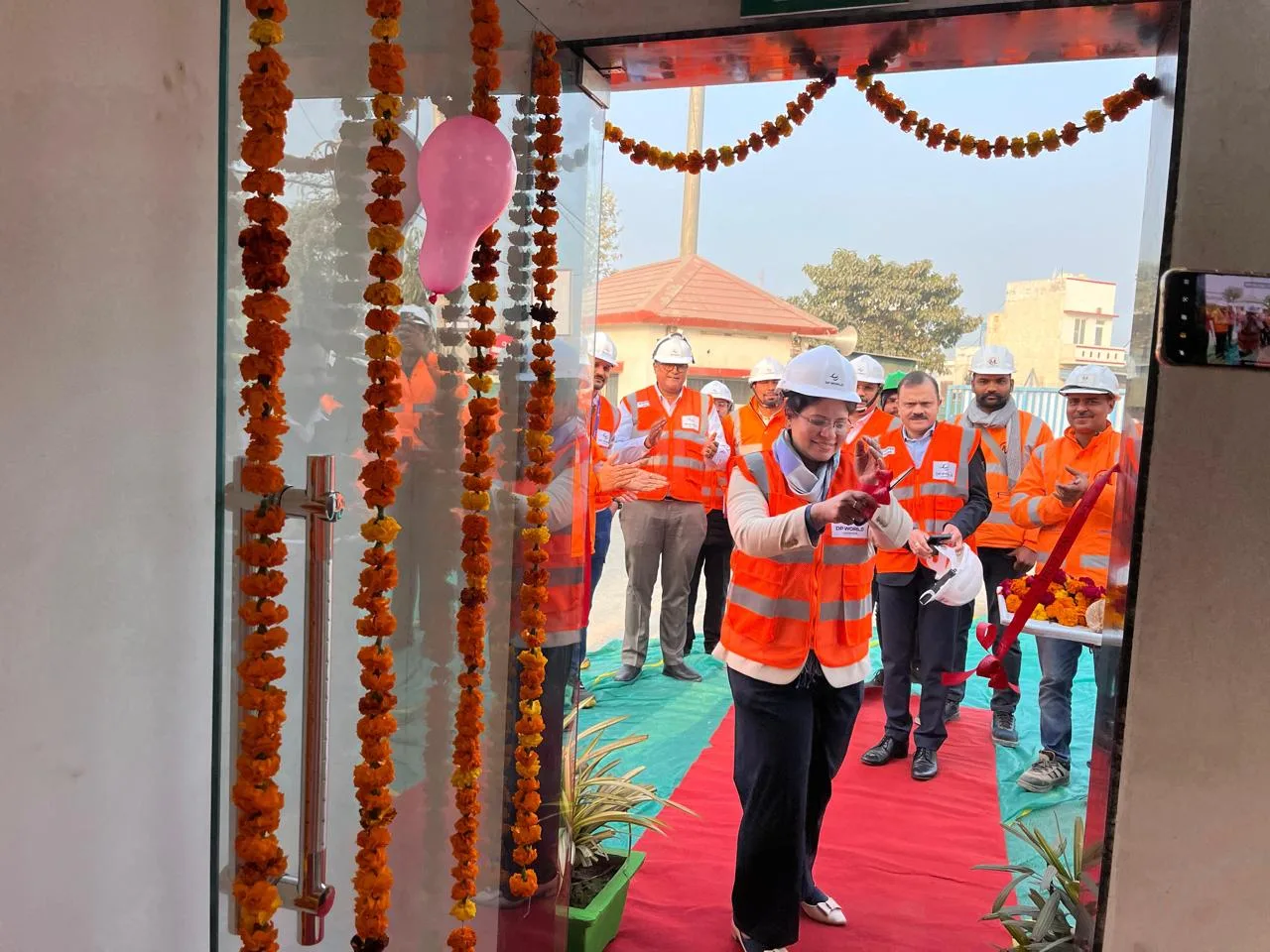 DP World official cutting the ribbon at a facility entrance